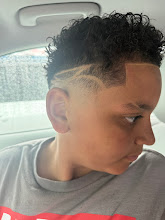Curly top fade with a shaved side design